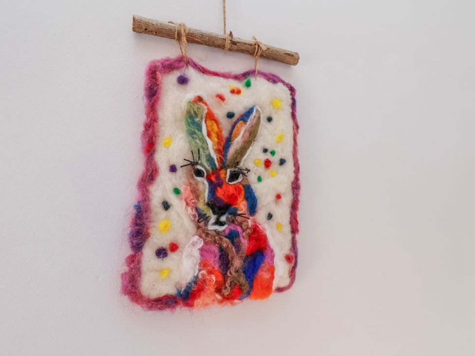 A colorful rabbit artwork hanging on a wall at 1 West Ville Mews in York