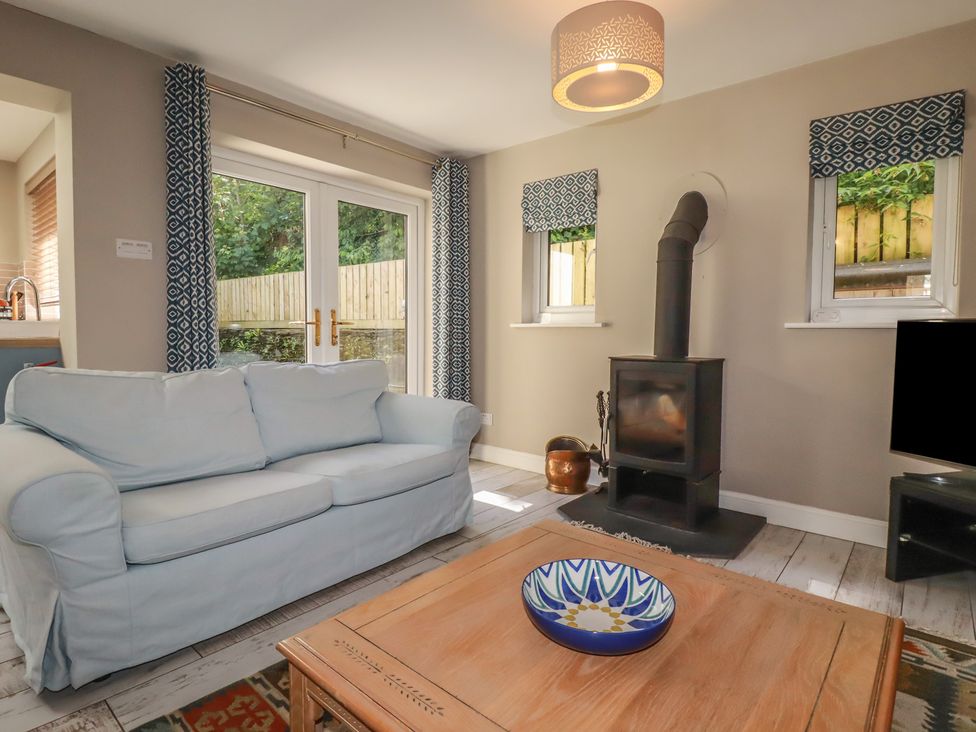 A living room with a sofa and coffee table at Stowaway Cottage Padstow