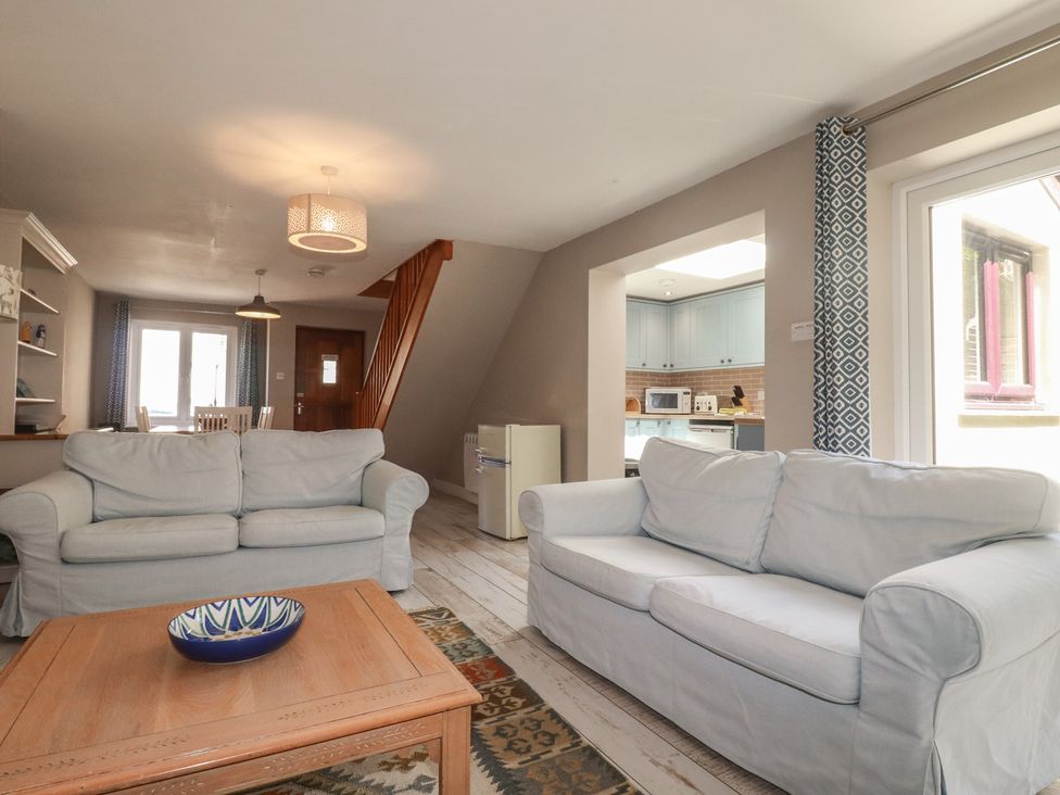 A living room with sofas and a coffee table at Stowaway Cottage in Padstow