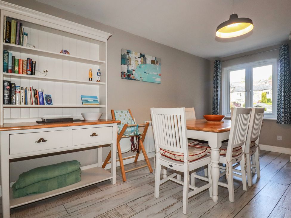 A dining room with a table and chairs at Stowaway Cottage in Padstow