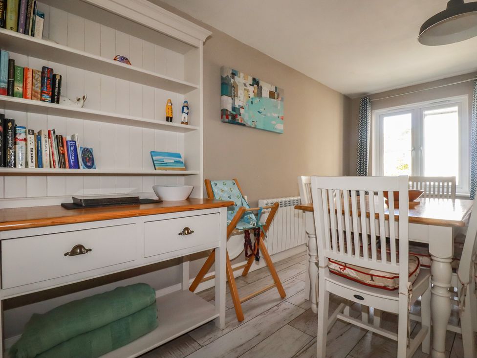 A dining room with a table and chairs at Stowaway Cottage in Padstow