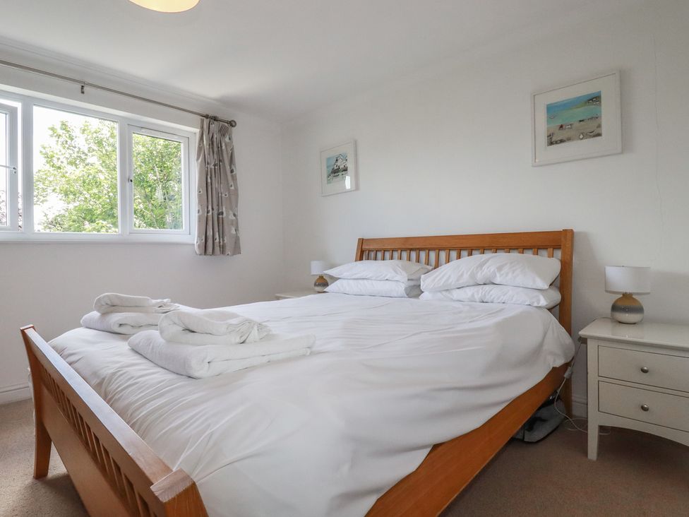 A bedroom with a double bed and bedside tables at Stowaway Cottage in Padstow