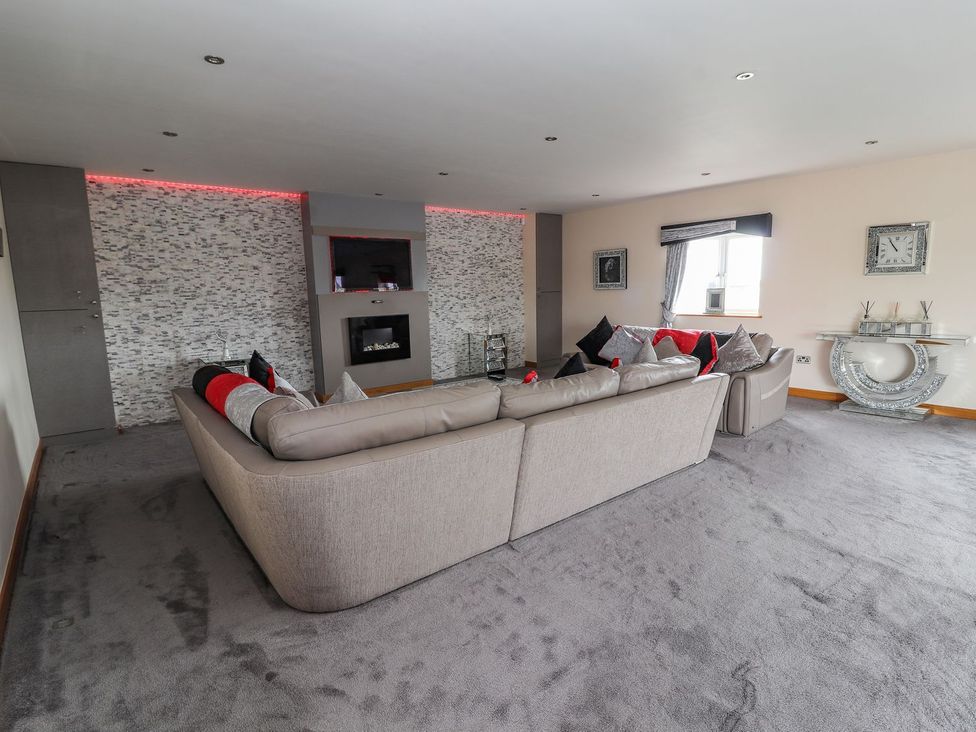 A living room with a sofa and fireplace at The Wendover in Abergele