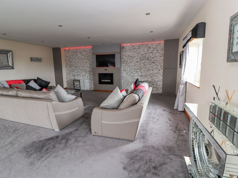 A living room with sofas and a TV unit at The Wendover in Abergele