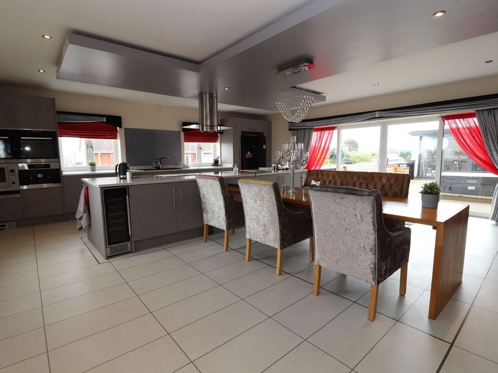 A kitchen with a dining area and appliances at The Wendover in Abergele