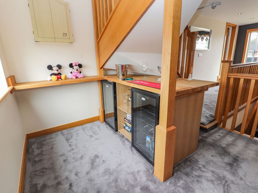 A hallway with a bar counter and plush toys at The Wendover in Abergele