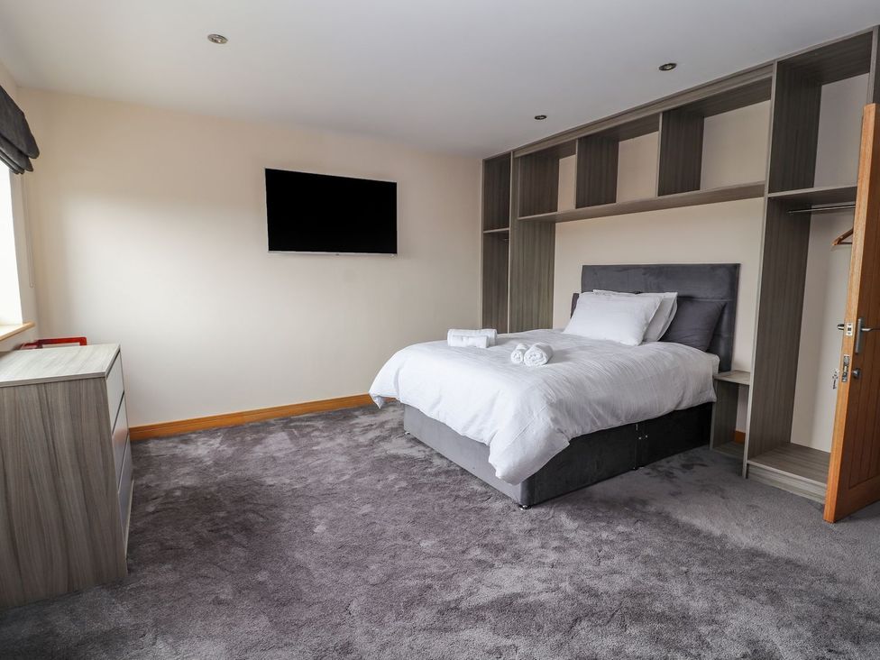 A bedroom with a bed and television at The Wendover in Abergele