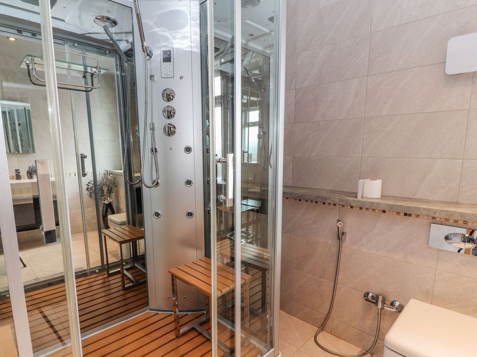 A bathroom with a shower and toilet at The Wendover in Abergele