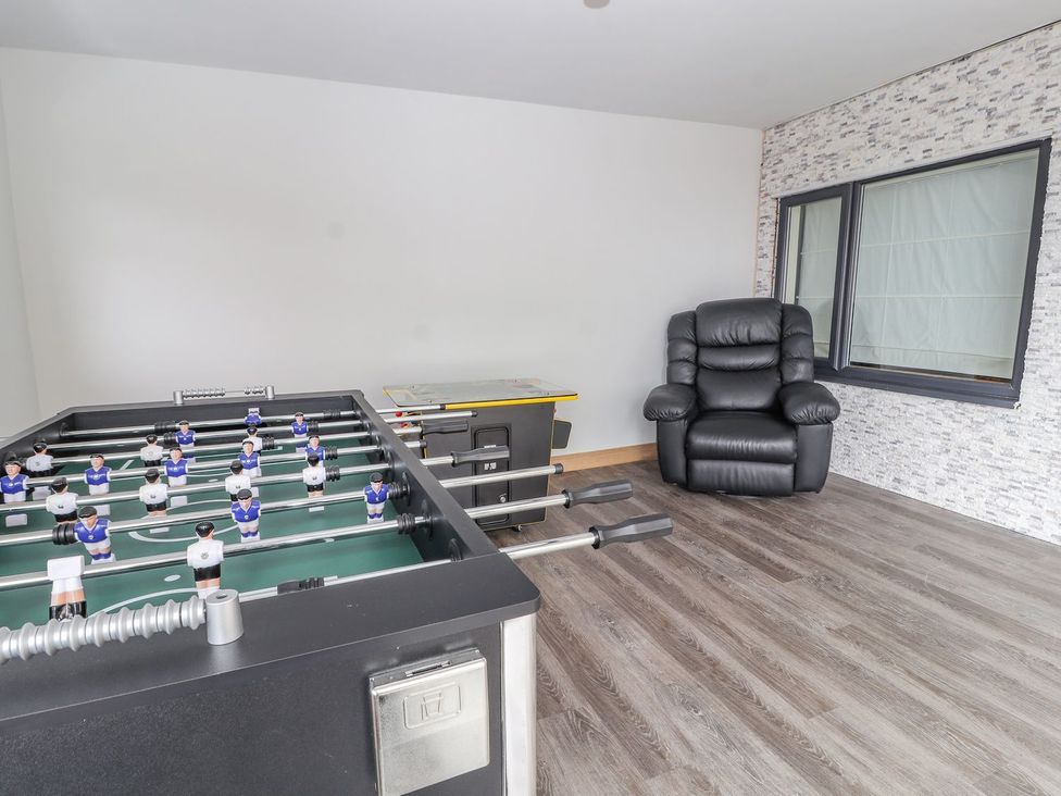 A game room featuring a foosball table and a recliner chair at The Wendover in Abergele