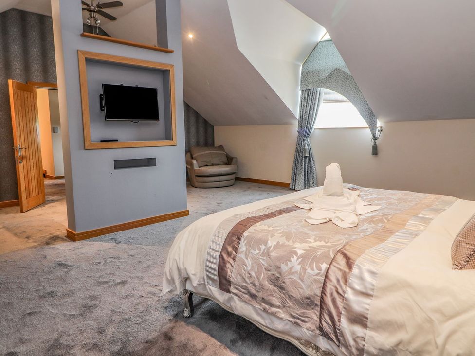 A bedroom with a bed and a television at The Wendover in Abergele