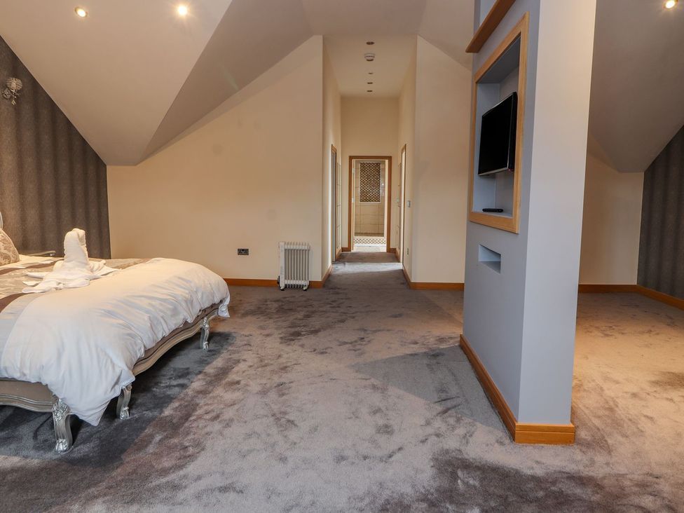 A bedroom with a bed and television at The Wendover in Abergele