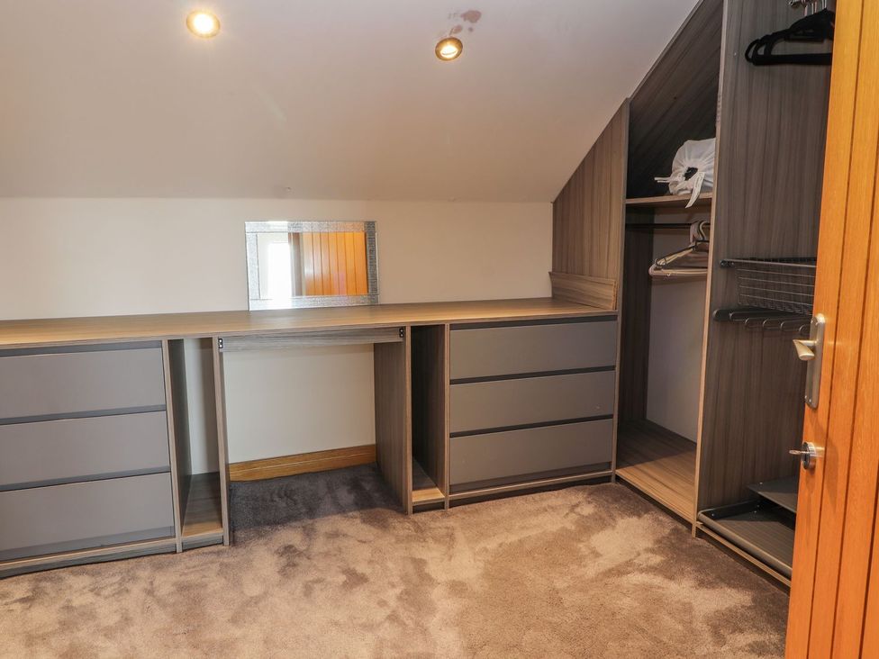 A dressing room with a closet and drawers at The Wendover in Abergele