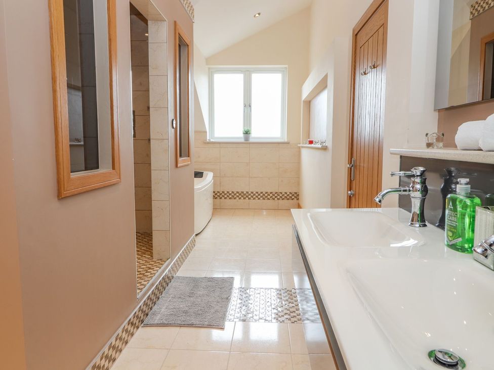 A bathroom with a sink, toilet, and shower at The Wendover in Abergele