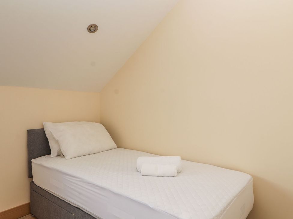 A bedroom with a bed and towel at The Wendover in Abergele