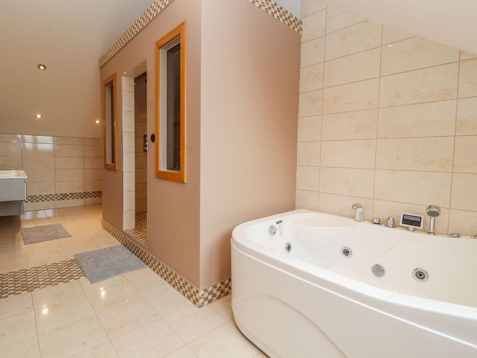 A bathroom with a bathtub and shower at The Wendover in Abergele