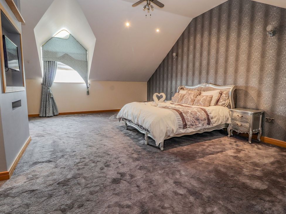 A bedroom with a bed and a bedside table at The Wendover in Abergele