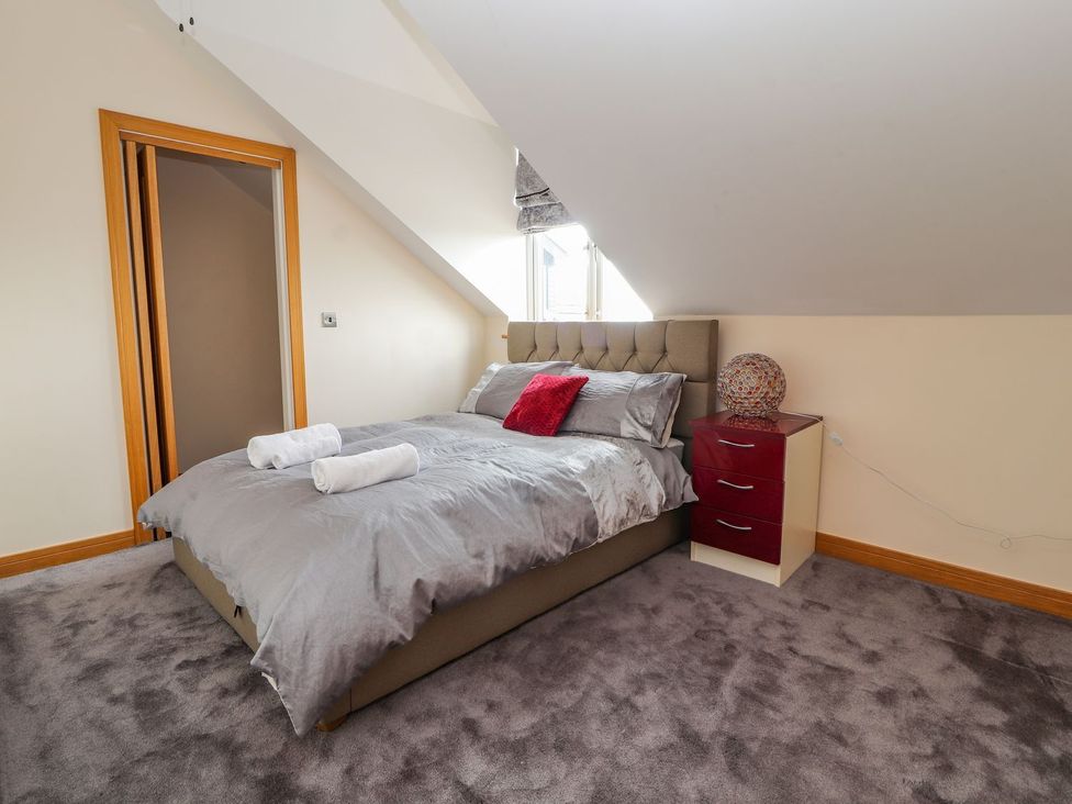 A bedroom with a bed and a nightstand at The Wendover in Abergele