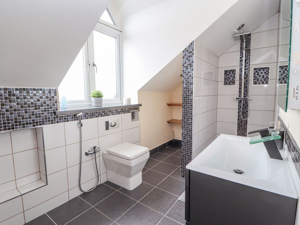 A bathroom with a shower and toilet at The Wendover in Abergele