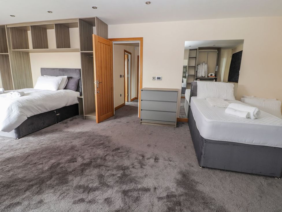 A bedroom with two beds and a dresser at The Wendover in Abergele