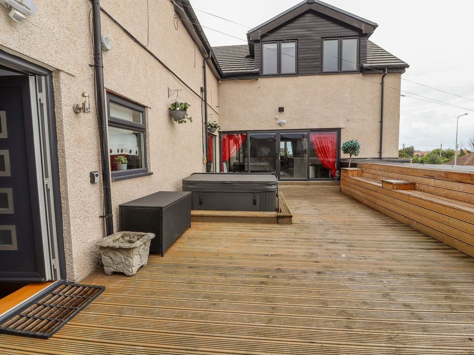 An outdoor space with decking and a hot tub at The Wendover in Abergele