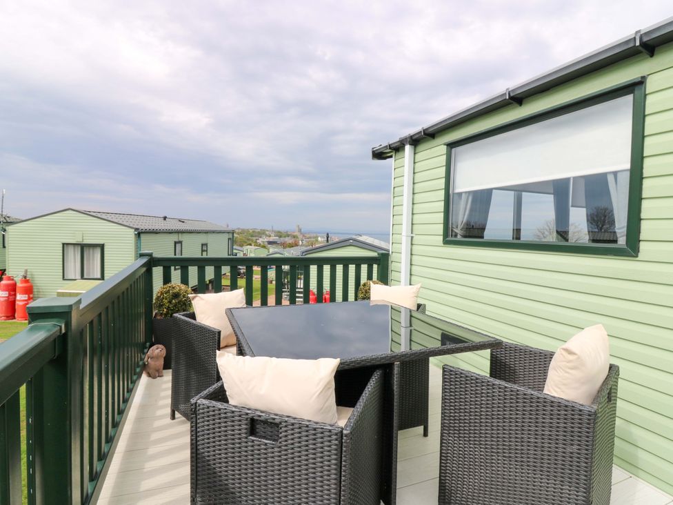 An outdoor seating area with a table and chairs at 18 Eden Heights in St Andrews