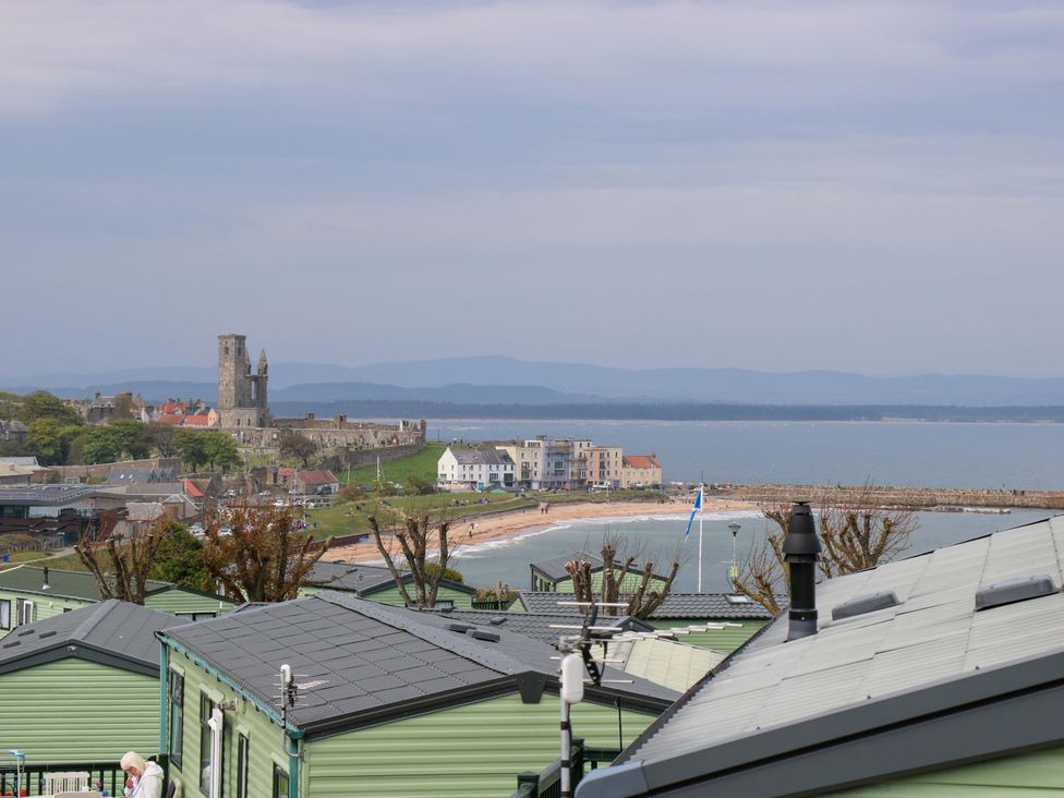A beach view with a castle in the background at 18 Eden Heights in St Andrews