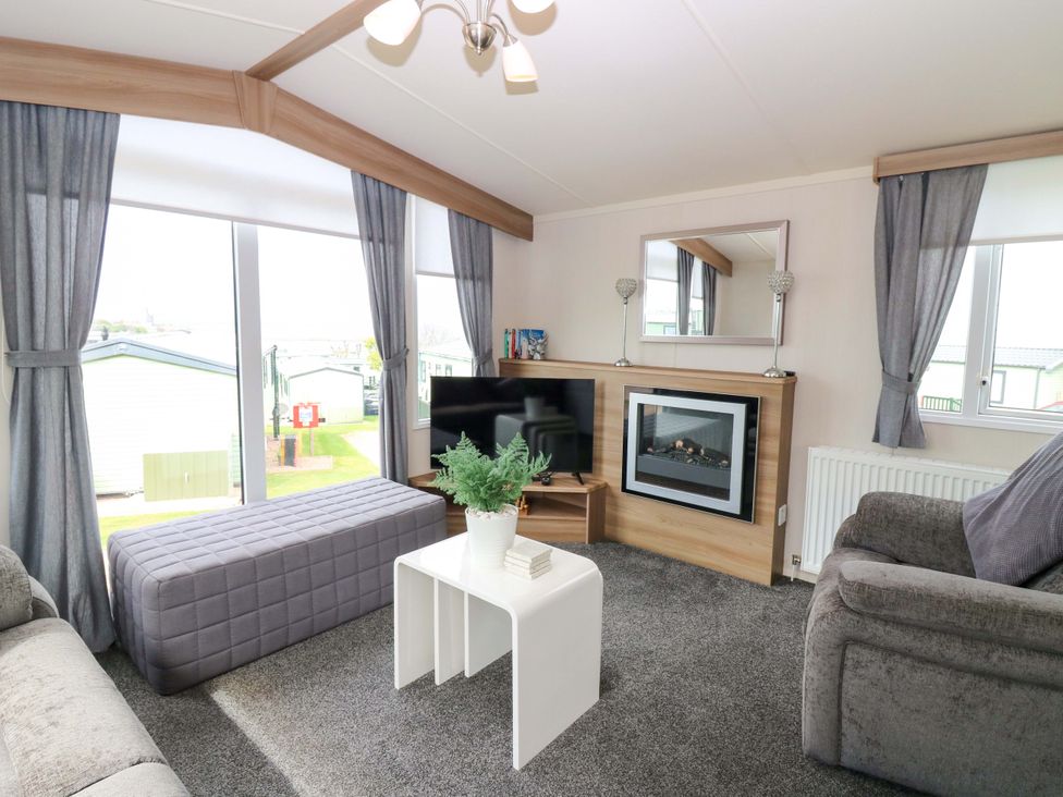 A living room with a television and fireplace at 18 Eden Heights St Andrews