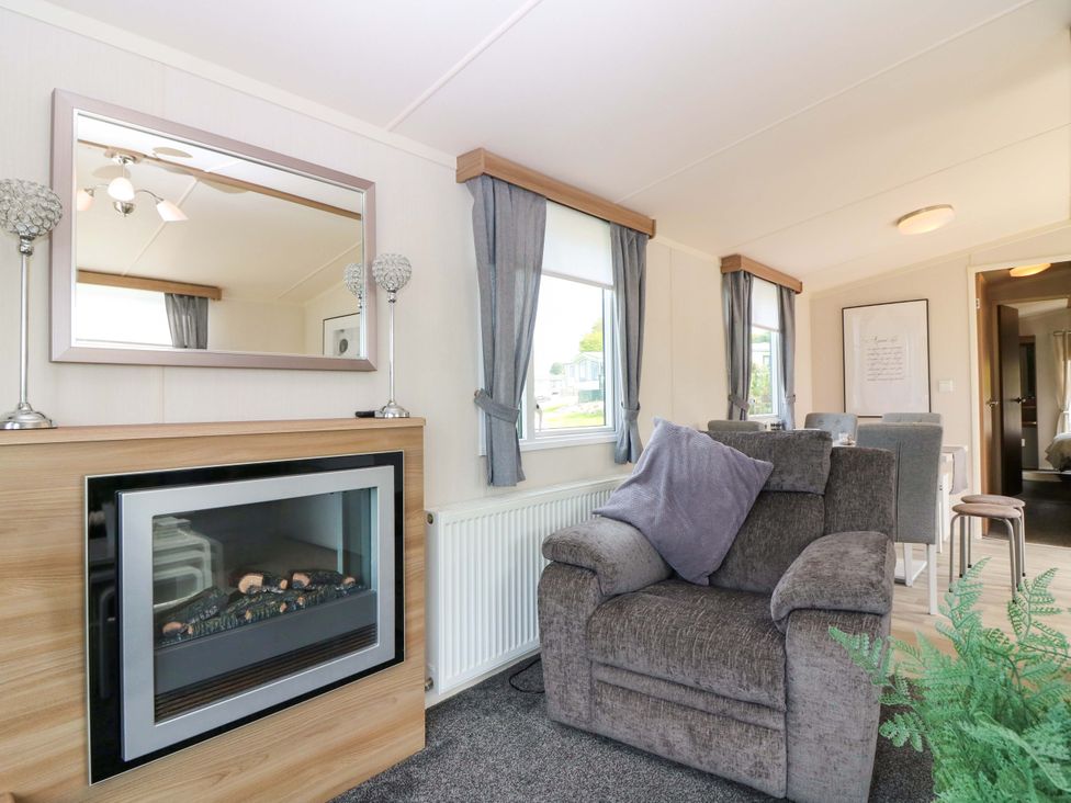 A living room with a fireplace and furniture at 18 Eden Heights in St Andrews