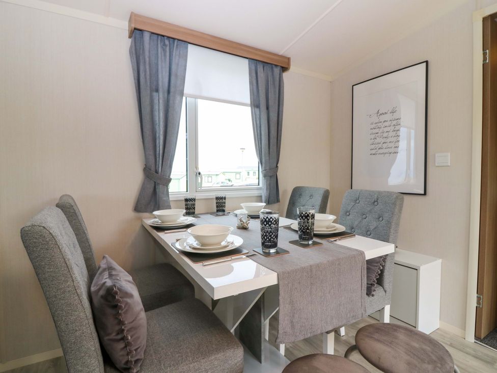A dining room with a table set for meals at 18 Eden Heights in St Andrews