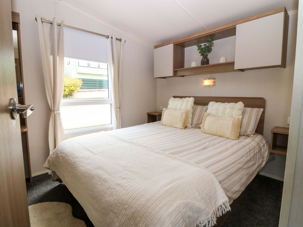 A bedroom with a bed and bedside table at 18 Eden Heights in St Andrews