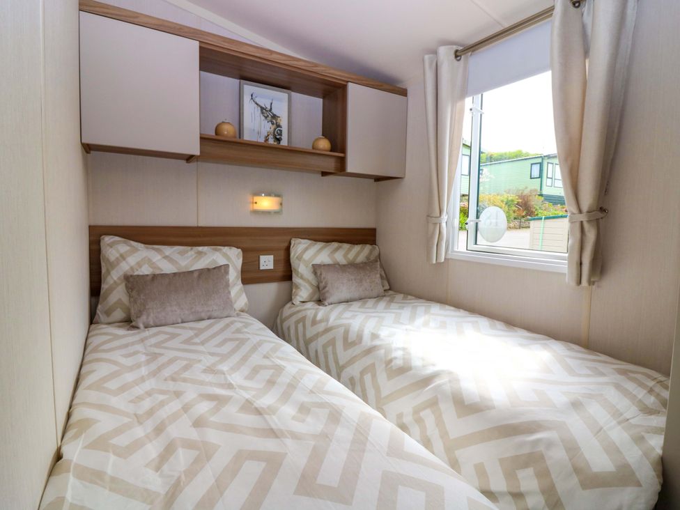 A bedroom with two beds and a window at 18 Eden Heights St Andrews