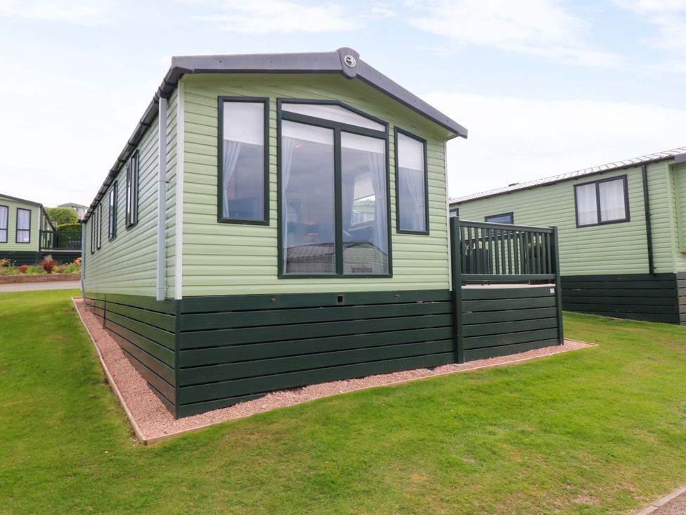A mobile home with windows and a deck at 18 Eden Heights St Andrews