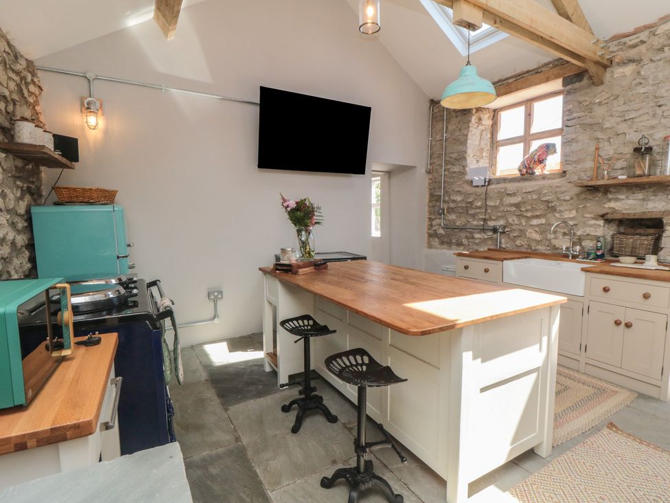 A kitchen with an island and sink at 1 bed York