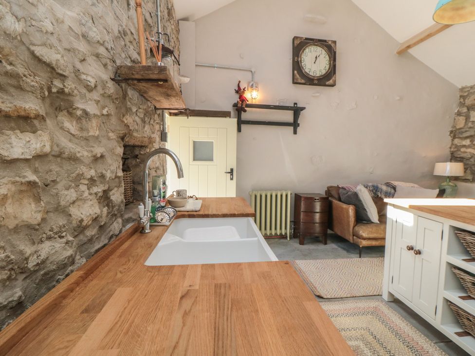 A kitchen with wooden countertops and stone walls at 1 bed in York