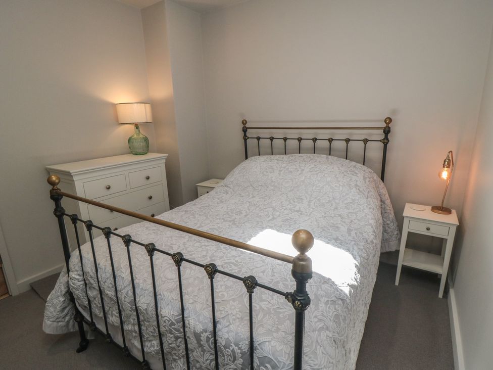 A bedroom with a bed and nightstand at 1 bed in York