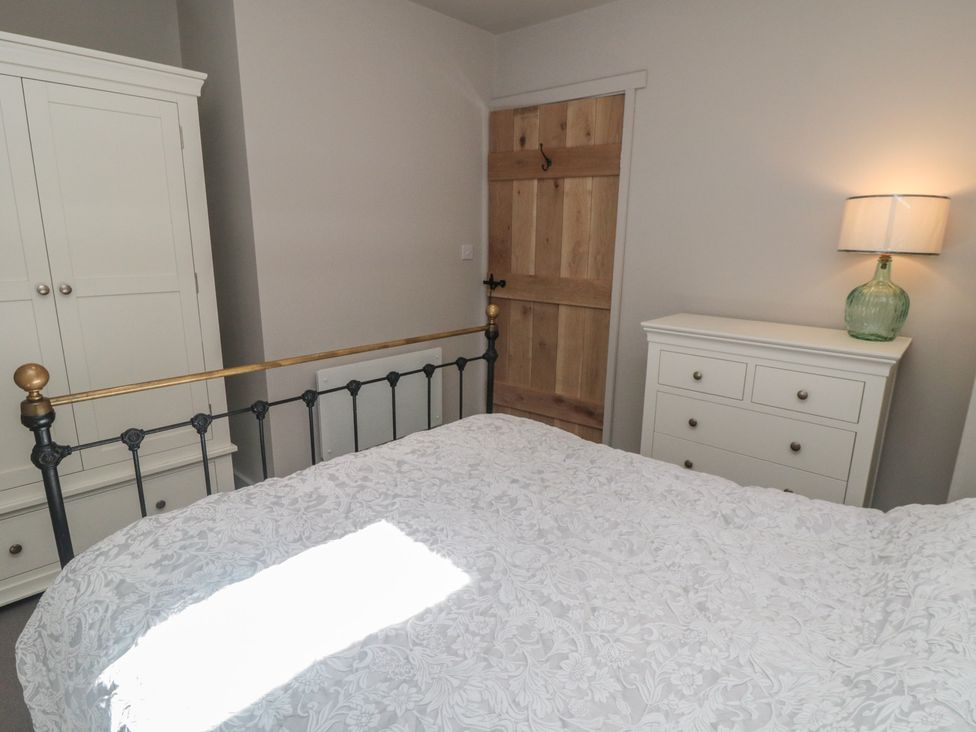 A bedroom with a bed, wardrobe, and a lamp at 1 bed in York