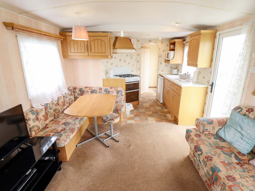 A living room with a sofa and table at Number 9 in Skegness