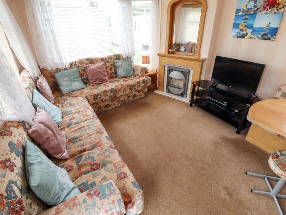 A living room with a sofa and television at Number 9 in Skegness