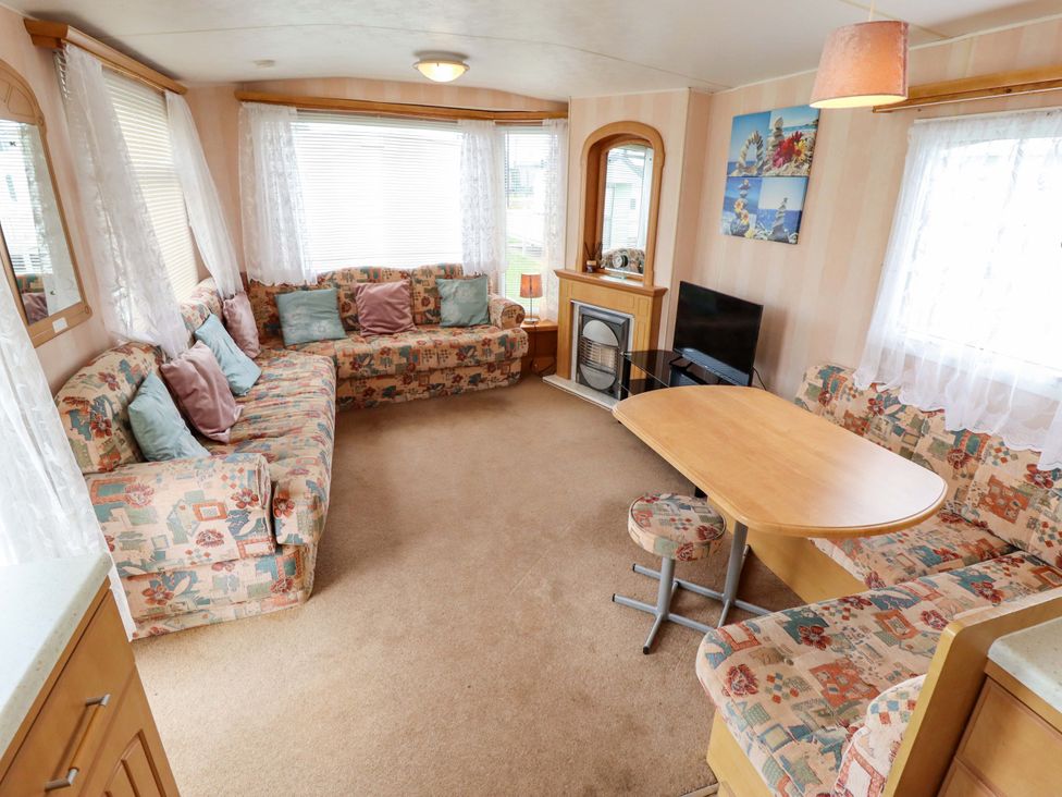 A living room with a sofa and table at Number 9 in Skegness