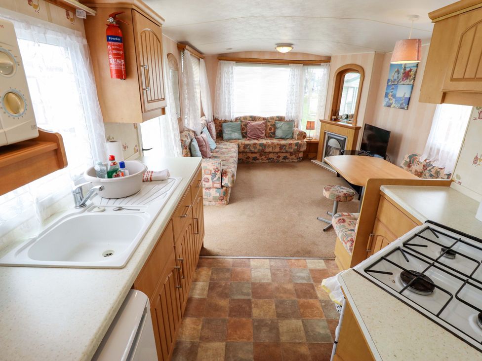 A kitchen and living area with a sofa and dining table at Number 9 in Skegness