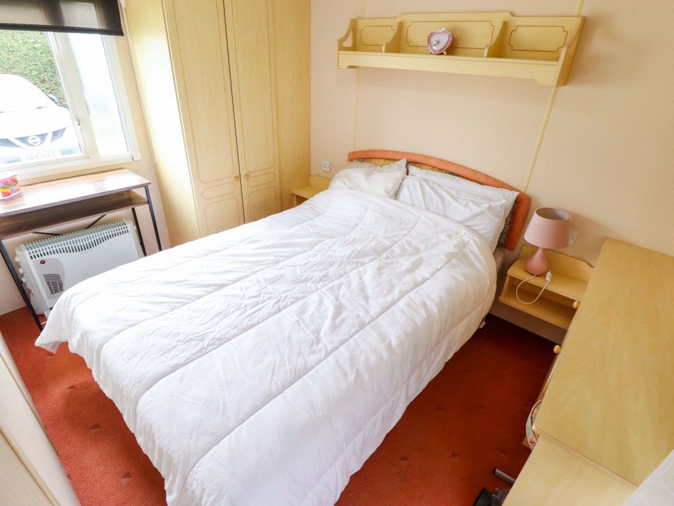 A bedroom with a bed and wardrobe at Number 9 in Skegness
