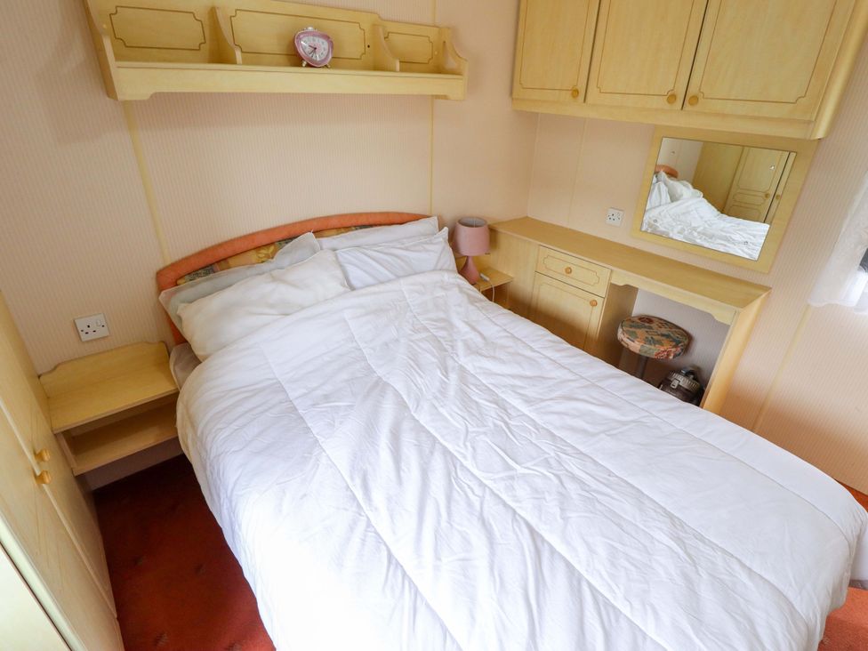 A bedroom with a bed and furniture at Number 9 Skegness