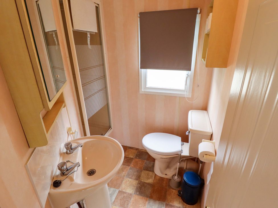 A bathroom with a sink, toilet, and shower at Number 9 Skegness