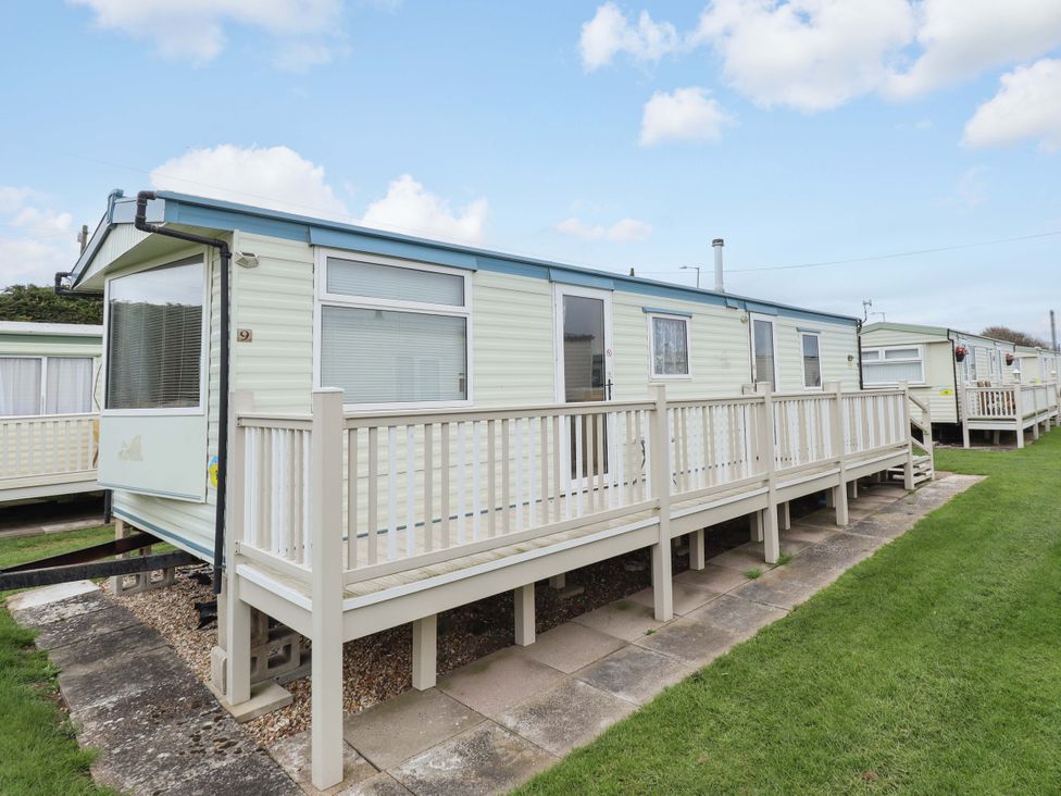 A static caravan with a porch and steps at Number 9 in Skegness