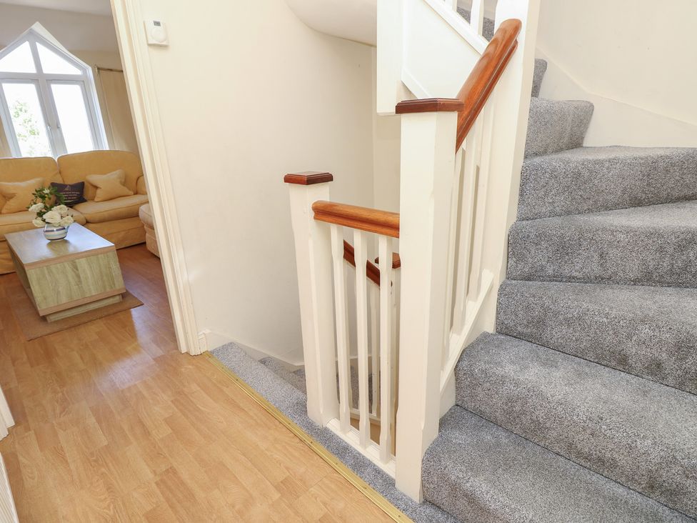 A staircase and living room view at Anchorage House Seaview