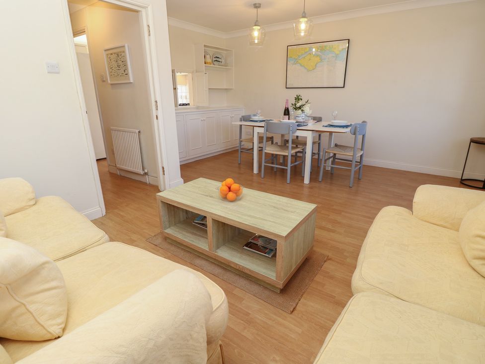 A living room with a coffee table and dining area at Anchorage House Seaview