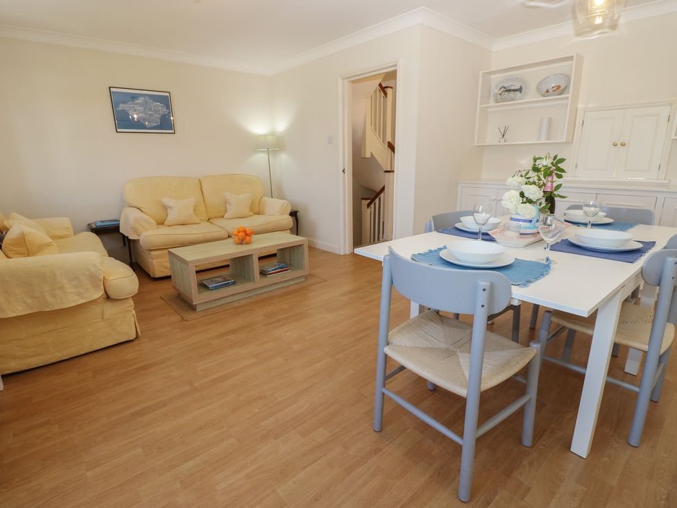A living room with a sofa and dining area at Anchorage House in Seaview
