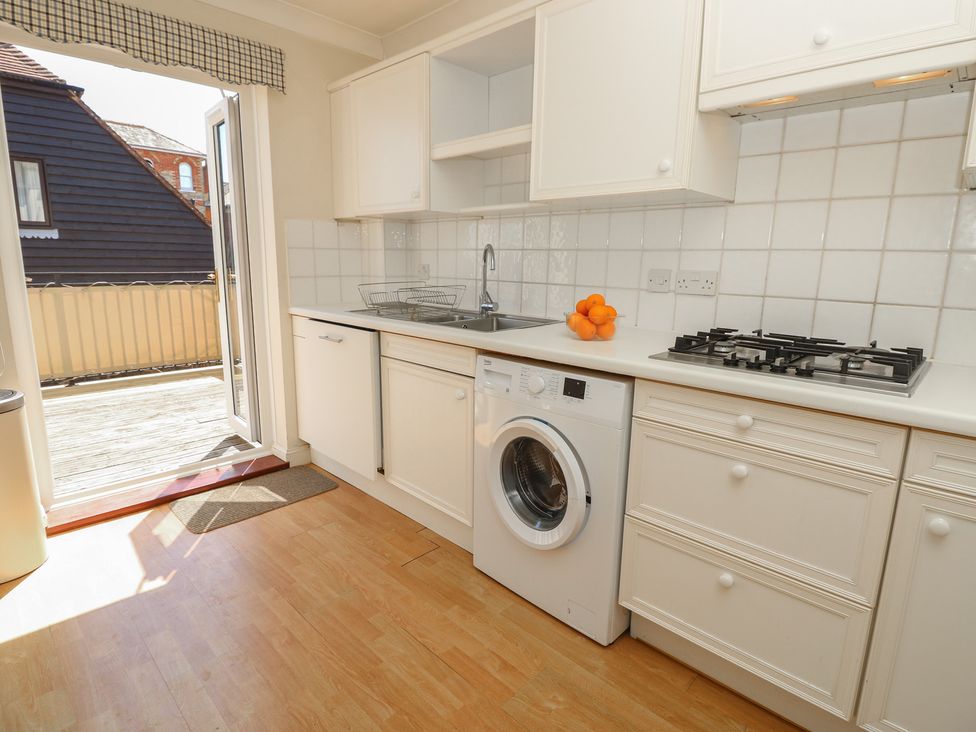 A kitchen with a sink and washing machine at Anchorage House in Seaview