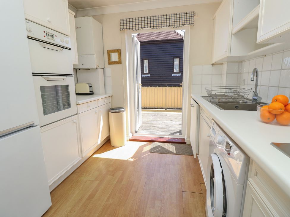 A kitchen with appliances and a door leading outside at Anchorage House Seaview