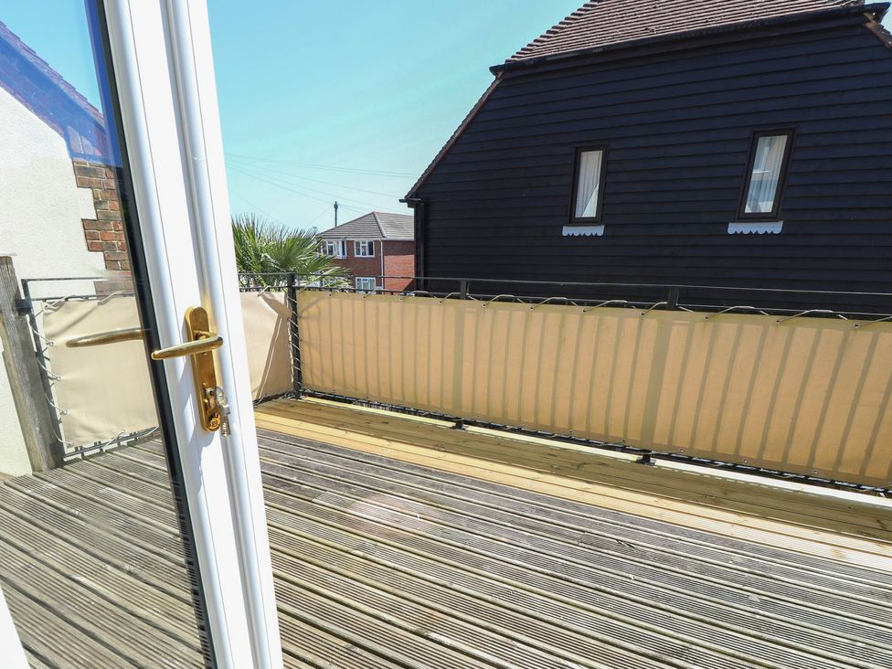 A balcony with wooden flooring and railing at Anchorage House in Seaview
